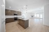 open kitchen with wood floors and island