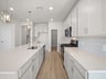 kitchen with quartz countertops, pendant lighting & an island