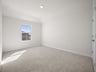 bedroom with carpet, window & a sloped ceiling