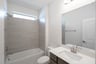 bathroom with tub and white countertops 