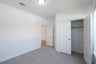 guest bedroom with carpet and closet 