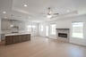 great room with fireplace and wood flooring 