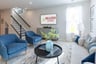 great room with blue velvet chairs and a couch