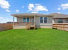 backyard with green landscaped grass