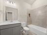secondary bathroom with soaking tub and sink