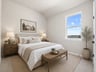 secondary bedroom with window, carpet and sloped ceilings