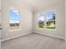 secondary bedroom with dual windows and carpet 