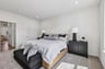 primary bedroom with a bench at the foot of the bed