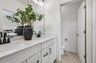 primary bathroom with a toilet room