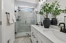 primary bathroom with a shower with a window
