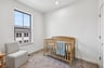 secondary bedroom with a crib