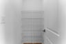 walk-in pantry with five wire shelves and a light