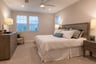 primary suite with a king-sized bed