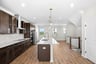 kitchen with an island with a sink and pendant lighting