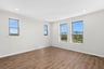 primary bedroom with several windows
