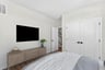 lower-level secondary bedroom with a mounted television