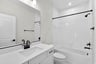 secondary bathroom with a shower and tub combination