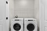 laundry with a washer, dryer and a shelf