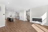 great room with a fireplace and access to the kitchen