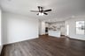 open great room with wood floors and ceiling fan