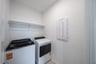 laundry room with tile floors, washer, and dryer