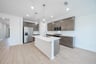 open kitchen with wood floors and island