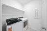 laundry room with tile floors, washer, and dryer