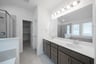 primary bathroom with soaking tub and walk-in shower
