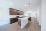 open kitchen with wood floors and island