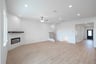 open great room with wood floors and fireplace