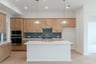 open kitchen with wood floors and island