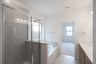 primary bathroom with soaking tub and walk-in shower