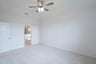 primary bedroom with carpet and ceiling fan