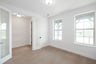 private study with wood floors and windows