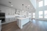 open kitchen with wood floors and island