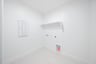 laundry room with tile floors and white shelf