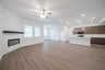 open great room with wood floors and fireplace