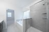 primary bathroom with soaking tub and walk-in shower