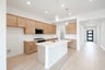 open kitchen with brown cabinets and hardwood flooring