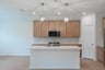 open kitchen with wood floors and island