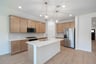 open kitchen with wood floors and island