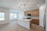 open kitchen with wood floors and island