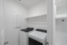 laundry room with tile floors, washer, and dryer