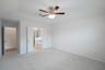 primary bedroom with carpet and ceiling fan