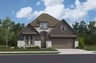 home with brick, windows, garage and landscaped grass 