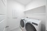 laundry room with tile floors, washer, and dryer