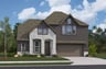 home with brick, windows, garage and landscaped grass 