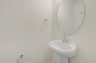 powder room with an oval mirror
