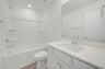 secondary bathroom with a shower and tub combo