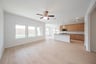 open great room with wood floors and ceiling fan